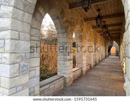 Cloistered stone archway of a suburban Chicago church at sunset during the winter solstice.