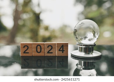 close up 2024 wooden text block, glass global and stethoscope on table, world health day, medical and healthcare, cardiology and cancer crisis risk and problem concept