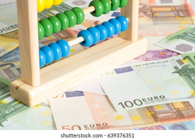 Close up of an abacus and many euro banknotes - Shutterstock ID 639376351