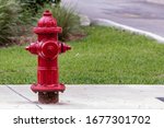 Close up of an above ground red pressurized wet-barrel fire hydrant and not a dry-barrel type plug found in Fort Lauderdale Florida, United States and Broward County.