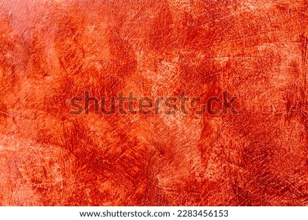 Close up abstract background, white concrete wall which is plastered with red oil paint feels hot unevenly, a classic pattern popular in construction of Thai houses or bathrooms.