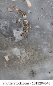 Close Up Abstract Of Icy Driveway With Leaf Dirt Gravel Background Pattern.