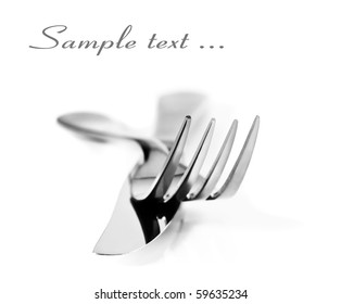 Close Up Abstract Of A Silver Knife And Fork On A White Background With Space For Text