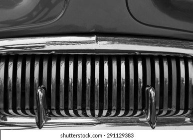 A close up abstract view of the front grill on an old scrap car