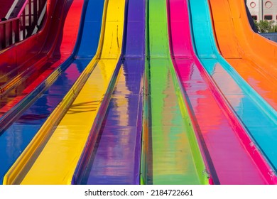 Close up abstract view of a large giant slide at the fairgrounds in rainbow colors