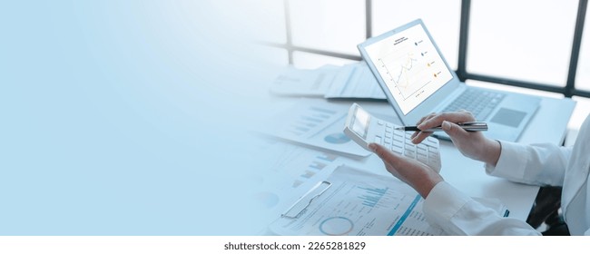 Close up accountant working on consolidated financial report of corporate operations, consultant auditing finance data (balance sheet, income statement) fintech. - Shutterstock ID 2265281829