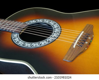 Close Up Of Acoustic Guitar Body On Black Background