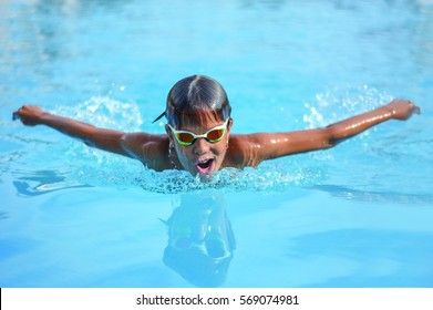 Close Up Action Shot Of Boy Swims Butterfly Stroke