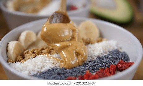 Close Up Of Adding Peanut Butter To The Organic Yummy Creamy Plant Based Smoothie Bowl