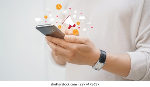 close up adult man hand hold smartphone to use affiliated marketing on web with virtual icon to announce campaign and promotion to social media network for referral partner program concept - Powered by Shutterstock