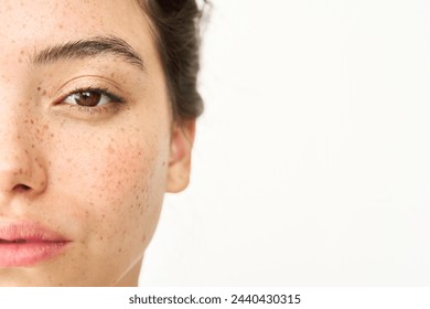 Close up aesthetic beauty half face portrait of Latin girl isolated on white background. Young adult pretty brunette Hispanic woman model with freckles looking at camera. Skincare cosmetic, skin care. - Powered by Shutterstock