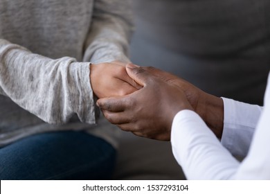 Close Up Of Affectionate African American Man Hold Caucasian Woman Hands Show Love And Care, Interracial Couple Having Tender Intimate Moment Together, Make Marriage Proposal Or Oath