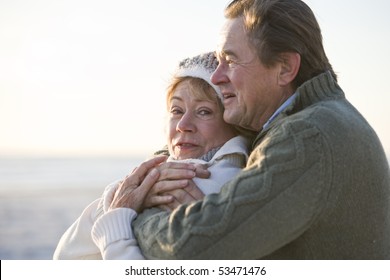 Close Up Of Affectionate Mature Couple Hugging And Staying Warm Outdoors