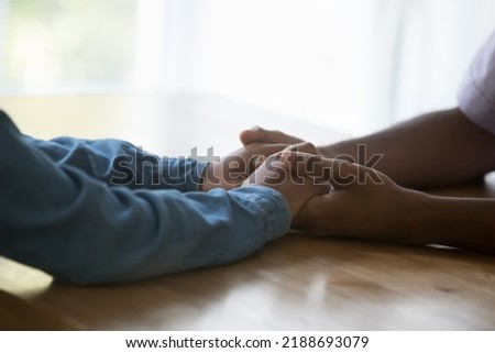 Close up African affectionate couple holding hands express support and trust. Caring guy give comfort, compassion, showing empathy to loving girl, touching arms while makes declaration on love