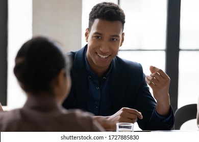 Close Up African American Businessman Talking With Female Colleague In Boardroom At Meeting. Black Man Speak With Businesswoman Negotiating About Business Project, Having Conversation.