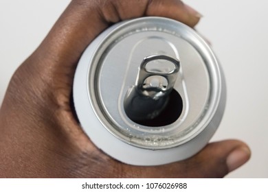 Close Up Of A African American Hand Holding An Open Can Beverage With Wet Bubbly Liquid Isolated On White Background. Hands Opening A Soda (beer) Can.