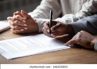 Close Up Of African American Husband Put Signature On Contract Buying First House With Wife, Multiracial Couple Sign Agreement Closing Deal With Realtor Or Banker, Taking Property Loan Or Mortgage