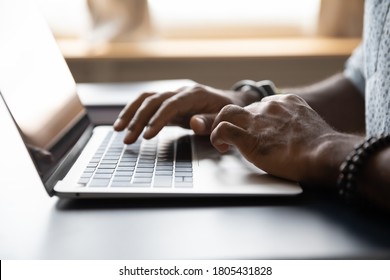 Close Up African American Male Hands Typing On Laptop Keyboard, Businessman Manager Freelancer Working On Online Project, Sitting At Work Desk, Using Computer, Man Chatting, Browsing Apps