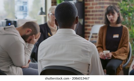 Close Up Of African American Man Discussing Alcohol Addiction At Aa Therapy Session. Adult Making Confession In Front Of Support Group People At Rehabilitation Program Meeting.