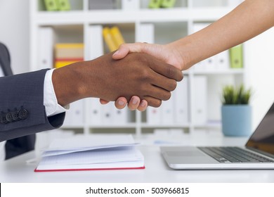 Close Up Of African American Man Shaking Hand With His His Female Colleague In Office. Concept Of Meeting