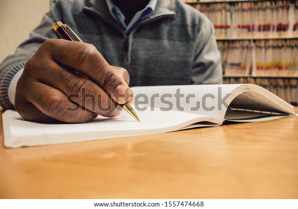 Close African American Man Writing Note Stock Photo (Edit Now) 1557474668