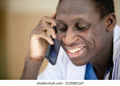 Close Up African American Medical Male Doctor Talking With Mobile Phone.