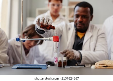 Close up of African American teacher demonstrating science experiments in school chemistry lab, copy space - Powered by Shutterstock