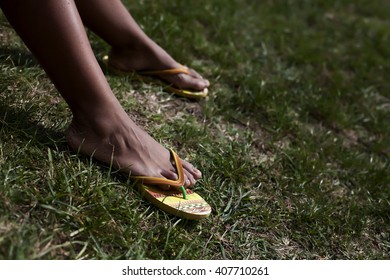 Close Up Of African American Woman Feet,sitting On The Grass. 