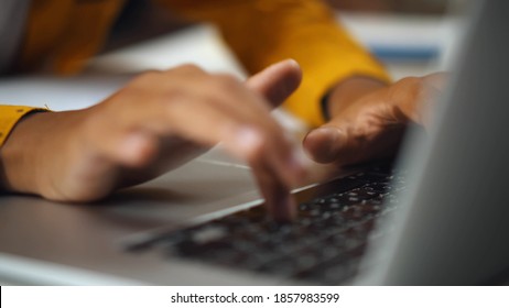 Close Up Of African Child Browsing Internet On Laptop. Hands Of Afro-american Boy Typing On Computer Doing Homework Or Playing Video Game At Home