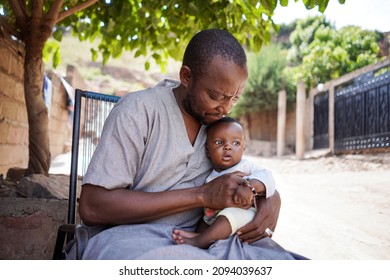 Close up African ethnicity father hold with care his small beautiful innocent child in his hands