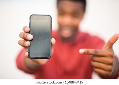 Close Up African Man Hands Holding Mobile Phone And Pointing To Screen