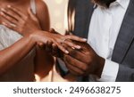 Close up of african man in love putting wedding ring on his woman finger