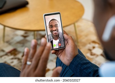 Close Up Of African Man On Video Call With Boss. Rear View Of Successful Black Business Man Taking Interviewing A Candidate Over Video Call Using Mobile Phone. Client Talking To Financial Advisor.