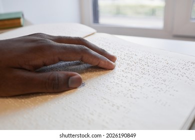 Close up of African-American hand reading braille book for blind, copy space - Powered by Shutterstock