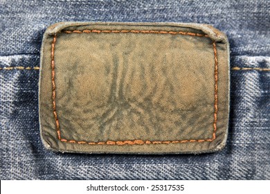 Close Up Aged Blank Leather Patch On The Back Of A Pair Of Jeans.