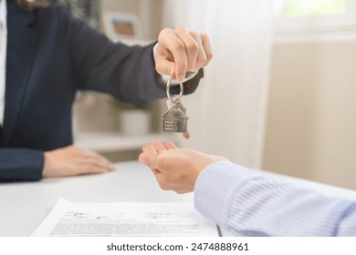 Close up agent giving a key to new owner or tenant, client after signed signature contract rental purchase, buyer apartment, home with landlord, realtor. Banker agreement mortgage loan. Property lease - Powered by Shutterstock