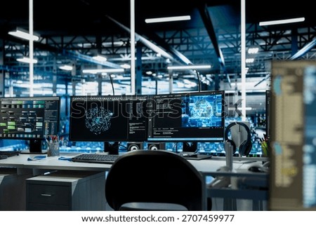 Close up of AI software interface on PC monitors in data center with mainframes hosting cloud services. Computers used for deploying deep learning algorithms in server farm used for automation tasks