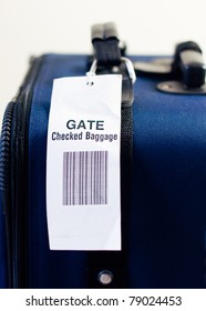Close Up Of Airline Checked Baggage Label On Blue Suitcase. Vertical View. Selective Focus.
