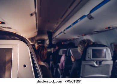 Close Up Of Airplane Aisle Seat In Fully Occupied Airplane Interior