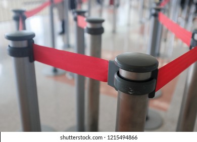 close up of airport stanchions for crowd control with retractable red belt - Shutterstock ID 1215494866