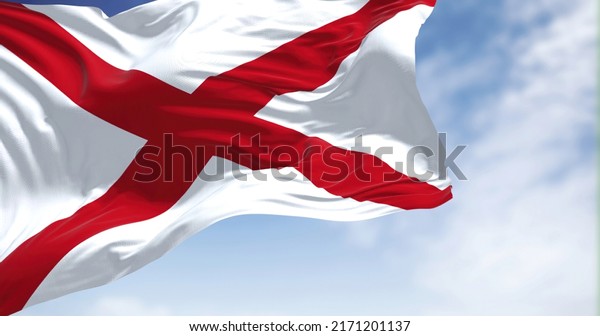 Close up of the Alabama\
state flag waving in the wind. Alabama is a state in the\
Southeastern region of the United States. Democracy and\
independence. American\
state.
