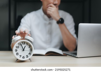Close up alarm clock with young Businessman using laptop analysis marketing plan and come up with new ideas in the night. Business, Finance and lifestyle concepts - Shutterstock ID 2195025271