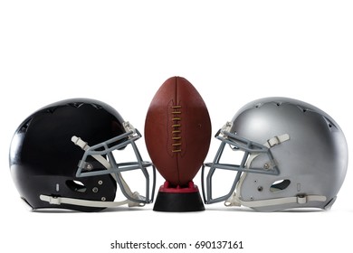 Close up of American football on tee by sports helmets against white baclground - Powered by Shutterstock