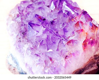 Close Up Of An Amethyst Stone. Textured Amethyst Crystal Or Geode In Purple, Violet, Lilac, Pink And Orange Colors With Spots. Prevents From Negative Energy, Used As Jewellery. 