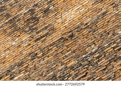 Close up of ancient brick wall texture pattern showcasing architecture of old ruin in Ayutthaya invoking feeling of timelessness and nostalgic awe at history and passage of time
