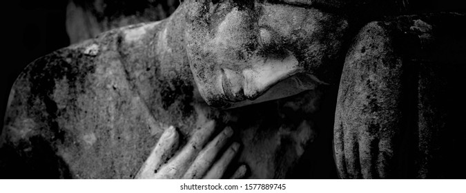 Close Up Ancient Stone Statue Of Sad Angel As Symbol Of Death And Pain.