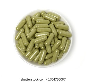 Close up Andrographis paniculata capsules in a white bowl (Herbal capsules) isolated on a white background,top view,with clipping path.
