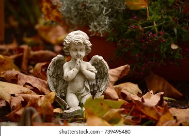 Close Up Of A Angel Child Statue By A Grave
