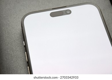 Close angle of the front module with pill-style cutout on a bright screen, clean macro detail.