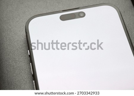 Close angle of the front module with pill-style cutout on a bright screen, clean macro detail.